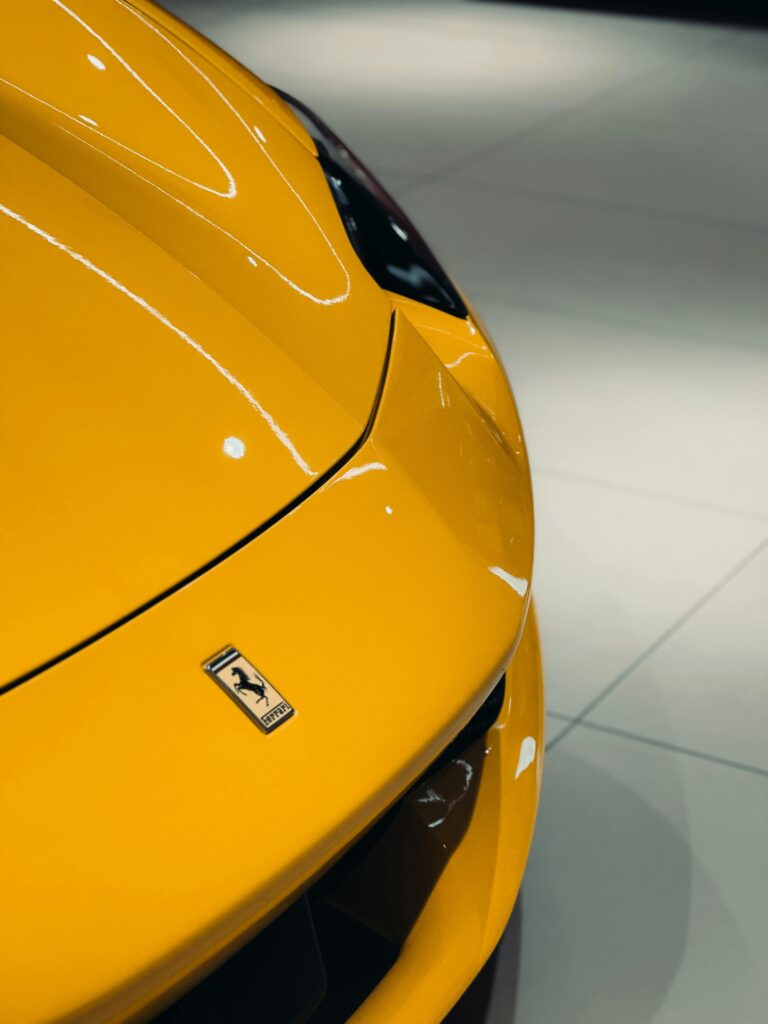 A sleek yellow sports car on display, showcasing elegant design and luxury.